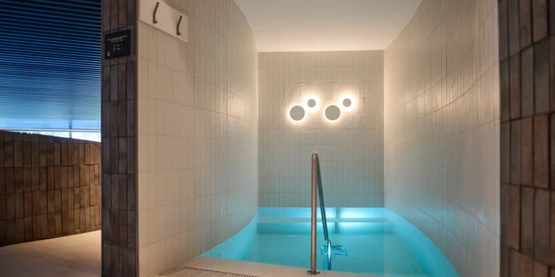 A small indoor pool with railings, softly lit, surrounded by tiled walls at Terme Catez